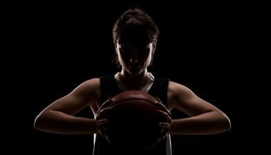 Female basketball player holding a basketball